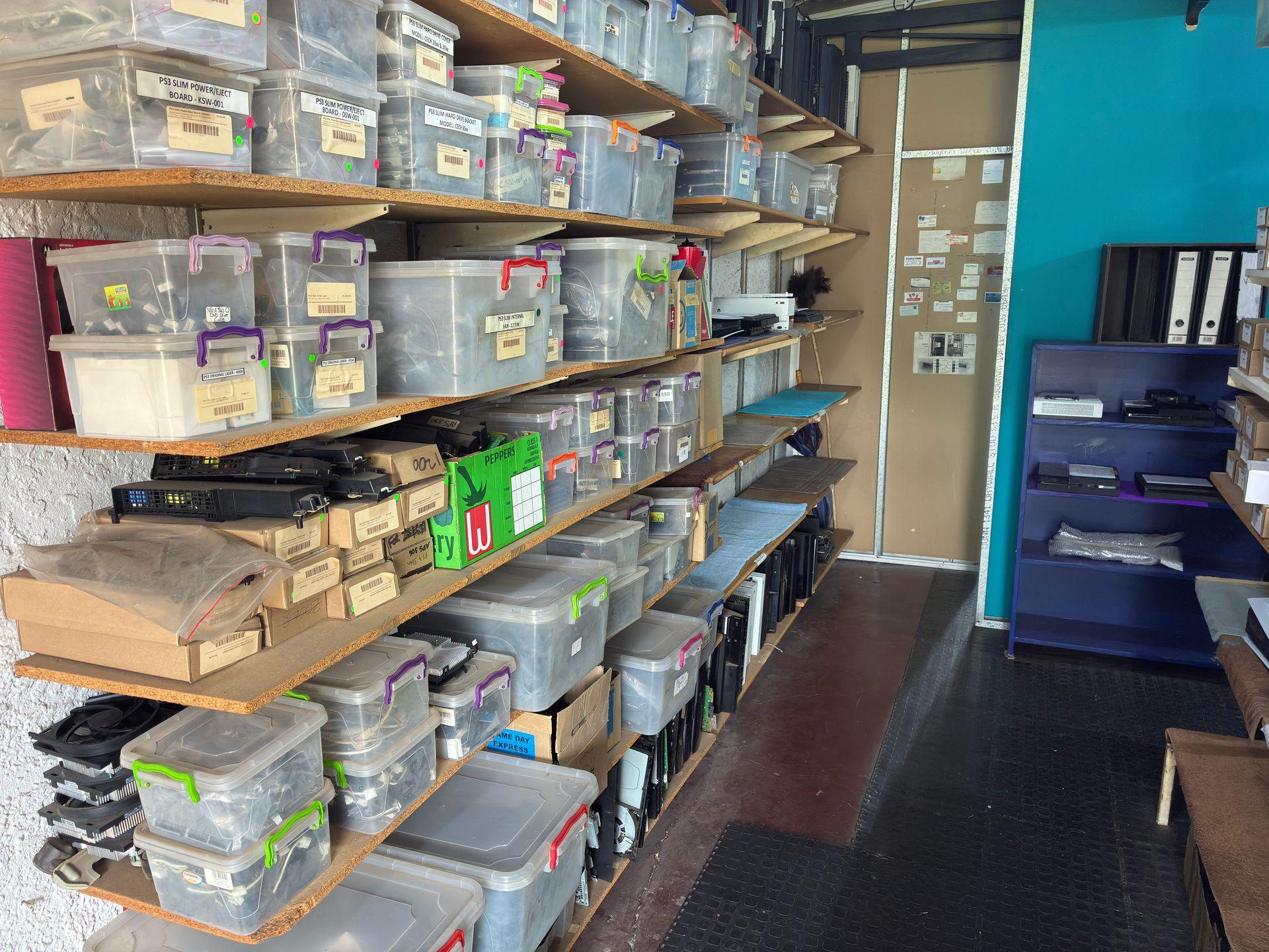 Organised console storage shelves with labelled bins at Console Service Centre